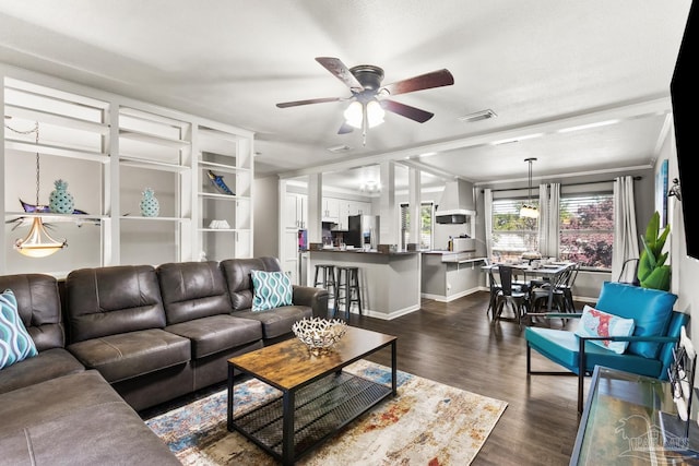 living room with dark wood-type flooring and ceiling fan