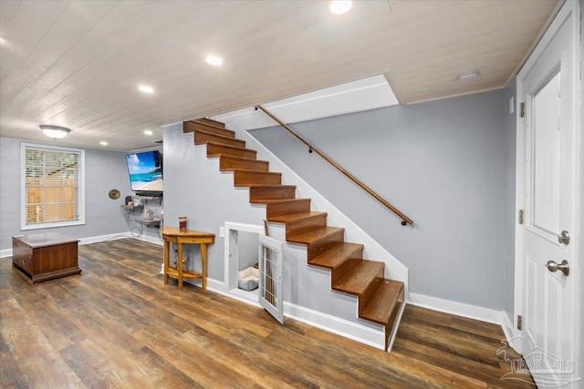 staircase with wood-type flooring and wood ceiling