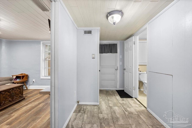 hall featuring wood ceiling and light hardwood / wood-style floors