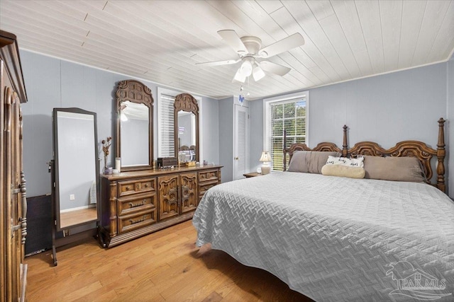 bedroom with ceiling fan, ornamental molding, wood ceiling, and light wood-type flooring