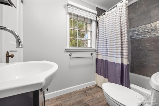 full bathroom with wood-type flooring, toilet, shower / bath combo, and sink