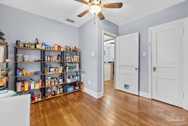 interior space with ceiling fan, wood-type flooring, and lofted ceiling