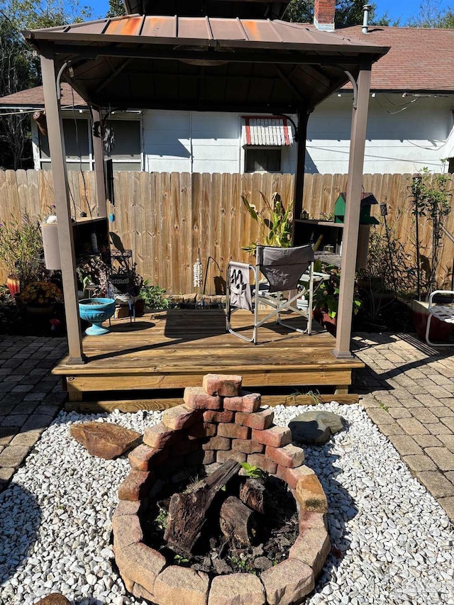 view of patio featuring a gazebo, an outdoor fire pit, and a deck