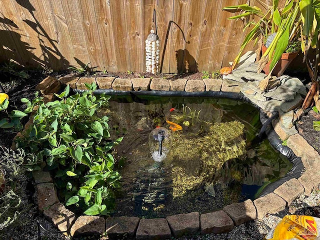 exterior details featuring a garden pond