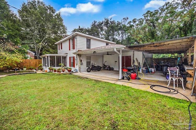 back of property featuring ceiling fan, a yard, a sunroom, and a patio area