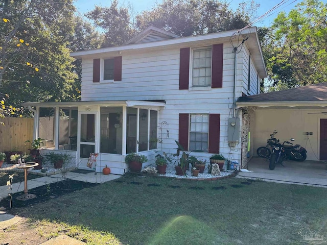 back of house featuring a sunroom and a yard