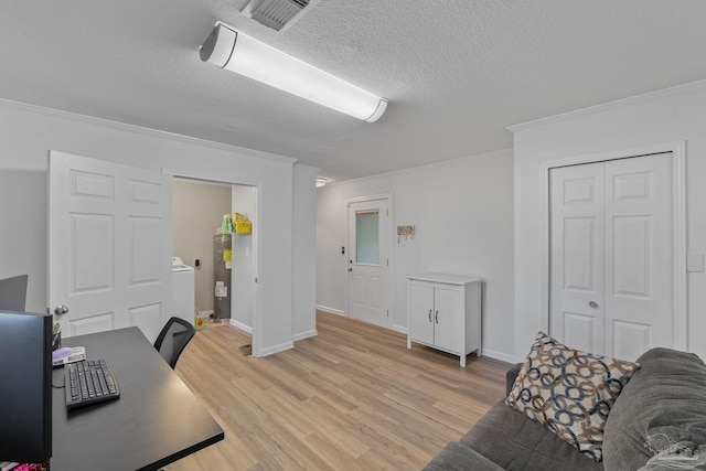 office area with visible vents, a textured ceiling, crown molding, light wood finished floors, and water heater