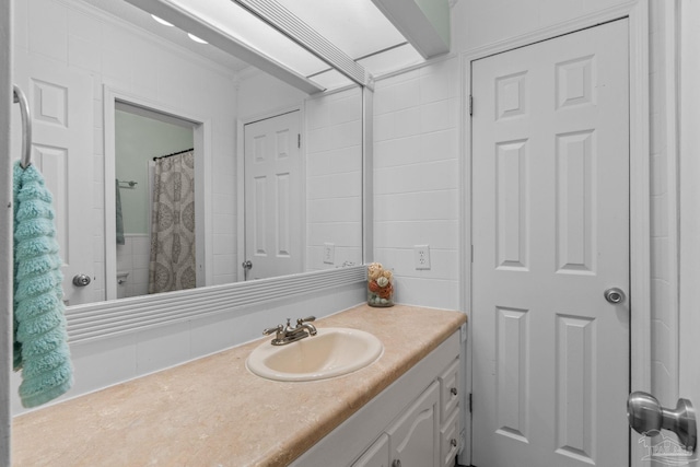 full bath featuring vanity and ornamental molding