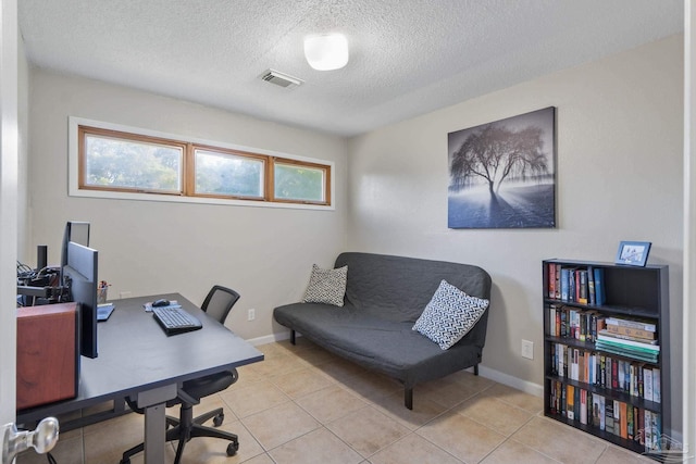 home office with visible vents, tile patterned floors, baseboards, and a textured ceiling