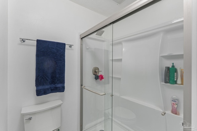full bathroom with toilet and a shower stall