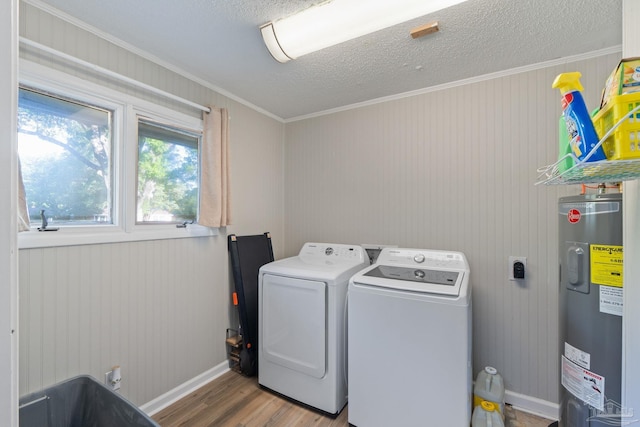laundry area featuring baseboards, separate washer and dryer, laundry area, electric water heater, and wood finished floors