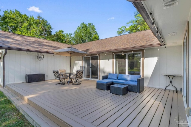 wooden deck with outdoor dining area and an outdoor hangout area
