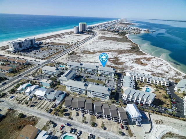 drone / aerial view with a water view and a beach view