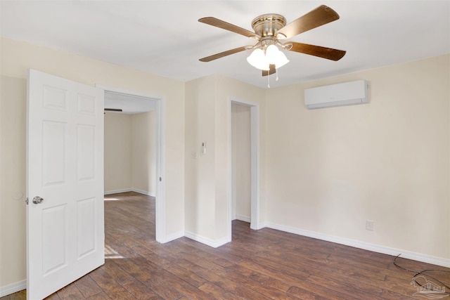 unfurnished room featuring ceiling fan, an AC wall unit, dark wood-style flooring, and baseboards