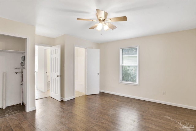 unfurnished bedroom with a ceiling fan, a closet, baseboards, and dark wood-type flooring