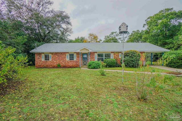 ranch-style home with a front lawn and a carport