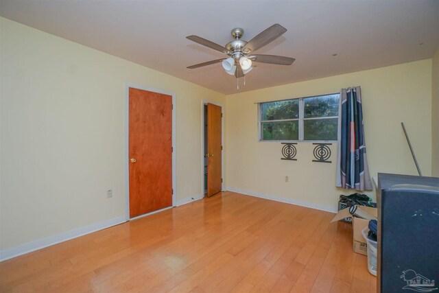 unfurnished office featuring ceiling fan and light hardwood / wood-style floors