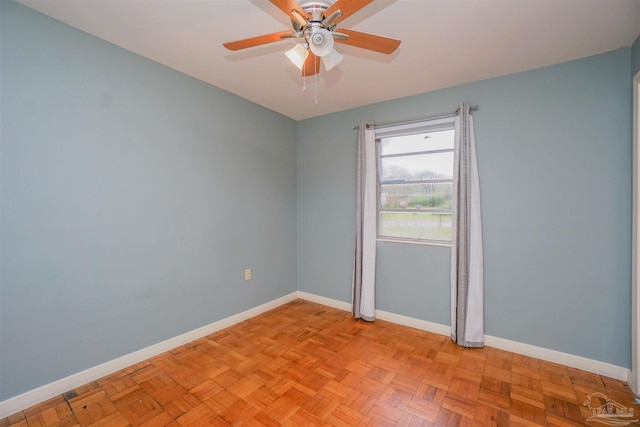 unfurnished room with ceiling fan and light parquet flooring