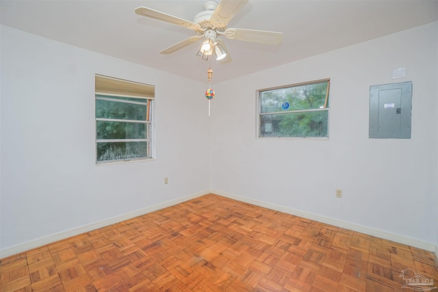 unfurnished room featuring electric panel, ceiling fan, and light parquet floors