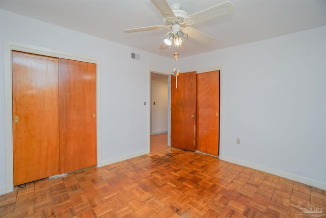 unfurnished bedroom with ceiling fan and light parquet floors