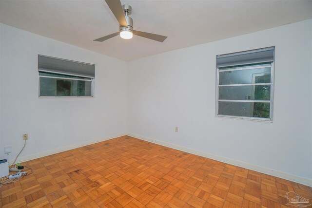 spare room featuring light parquet flooring and ceiling fan