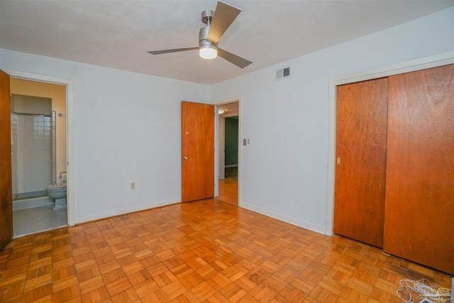 unfurnished bedroom featuring ensuite bath, ceiling fan, a closet, and light parquet floors