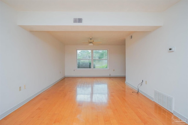 empty room featuring ceiling fan and light hardwood / wood-style flooring