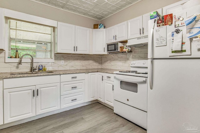 kitchen featuring light stone counters, sink, white appliances, light hardwood / wood-style flooring, and white cabinetry