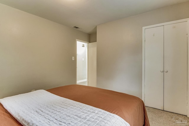 carpeted bedroom featuring a closet