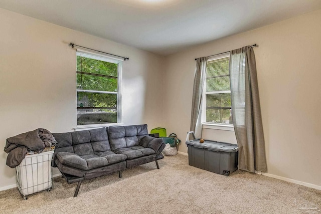 living room with plenty of natural light and light colored carpet