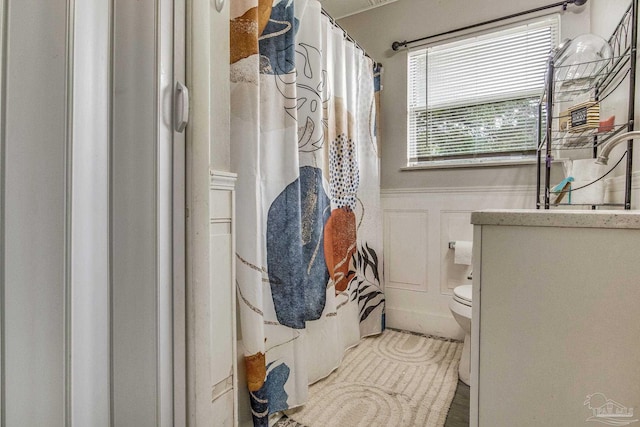 bathroom with vanity, toilet, and a shower with curtain