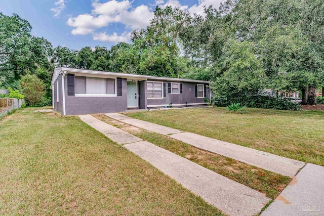 ranch-style home with a front lawn