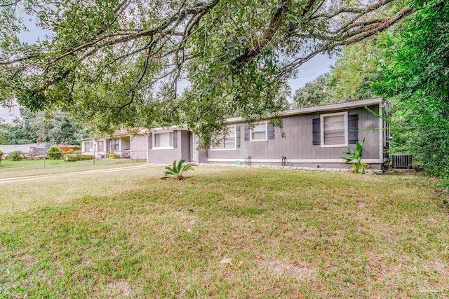 view of front of home featuring a front yard and central air condition unit