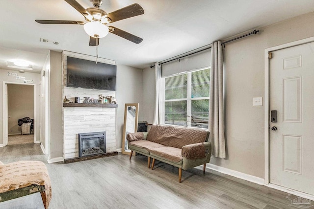 living room with wood-type flooring and ceiling fan