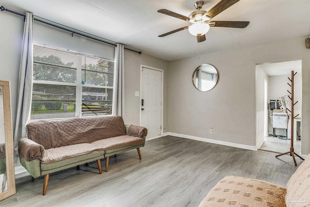 living room featuring ceiling fan and hardwood / wood-style flooring