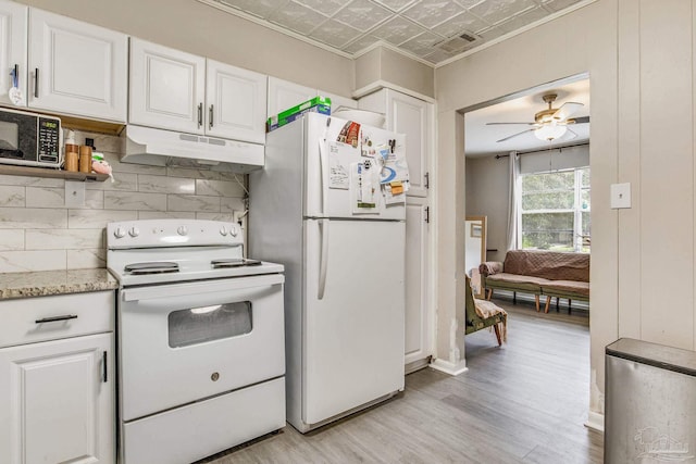 kitchen with light wood-type flooring, light stone counters, ceiling fan, white appliances, and white cabinetry