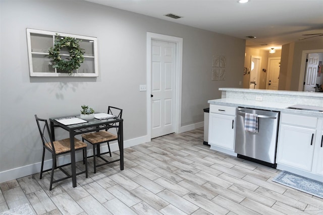 kitchen with light hardwood / wood-style floors, ceiling fan, sink, white cabinetry, and stainless steel dishwasher