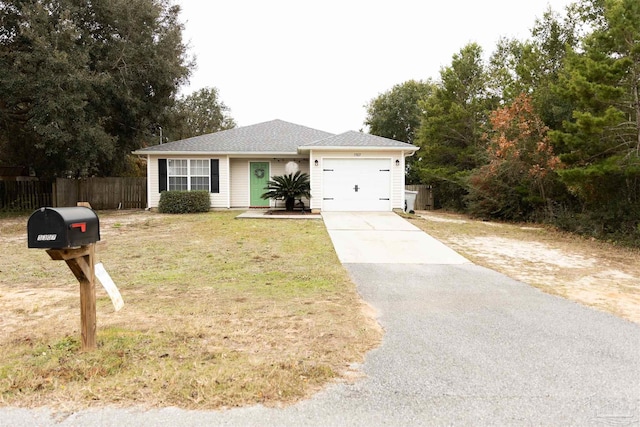 single story home featuring a garage and a front lawn