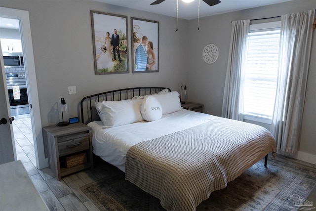 bedroom with ceiling fan and multiple windows