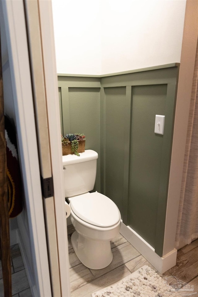 bathroom featuring toilet and hardwood / wood-style floors