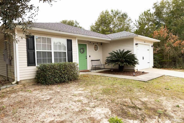 single story home with a garage and a front lawn