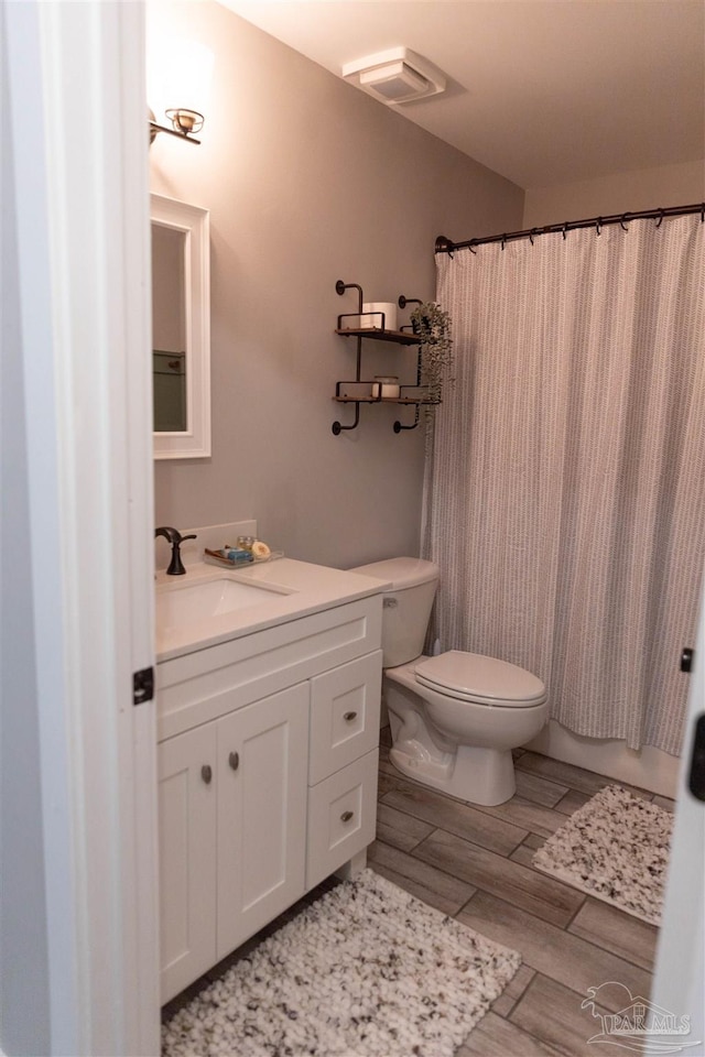 bathroom featuring toilet and vanity