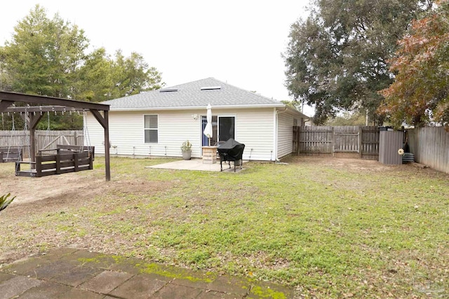 back of house with a patio and a yard