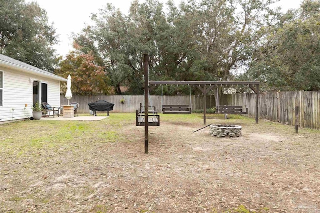 view of yard featuring a fire pit and a patio