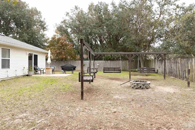 view of yard featuring a fire pit and a patio