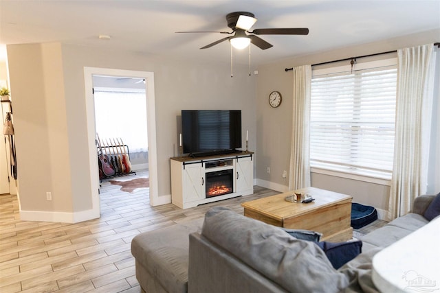 living room featuring ceiling fan and plenty of natural light