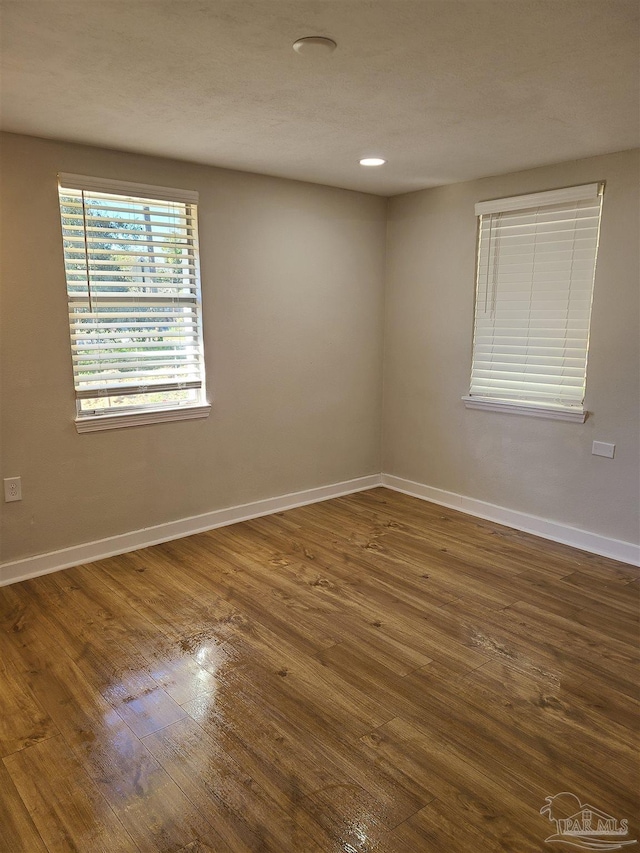 spare room featuring dark hardwood / wood-style floors