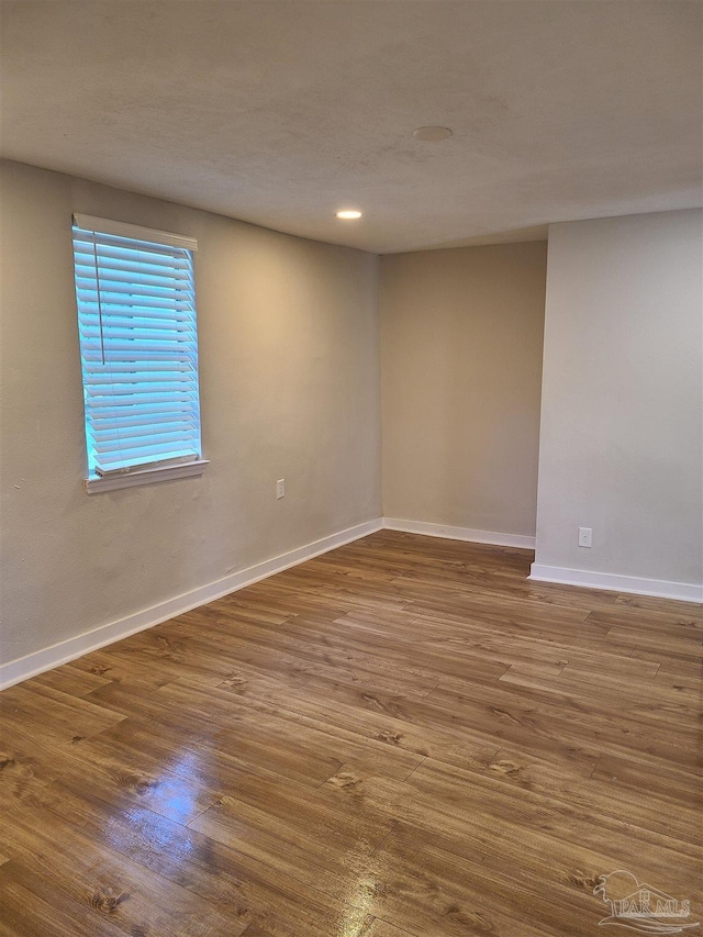 empty room with hardwood / wood-style floors