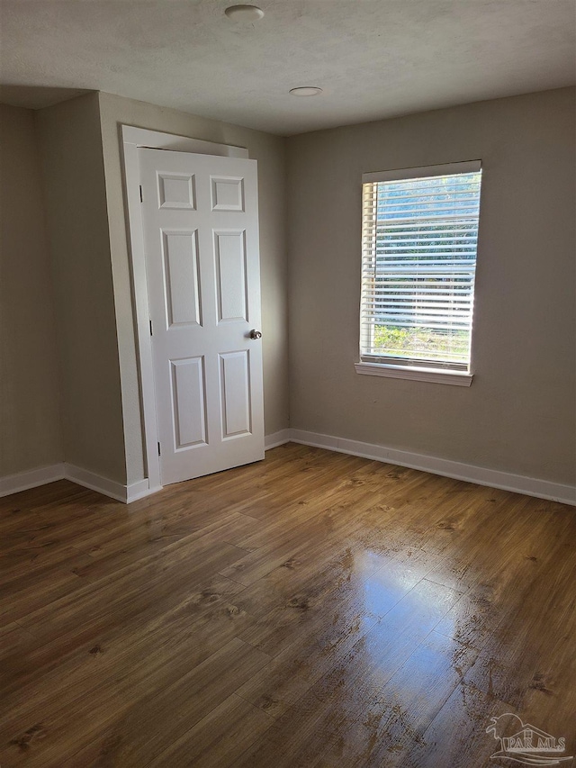 unfurnished bedroom featuring dark wood-type flooring