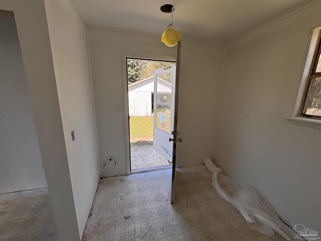 doorway to outside featuring crown molding